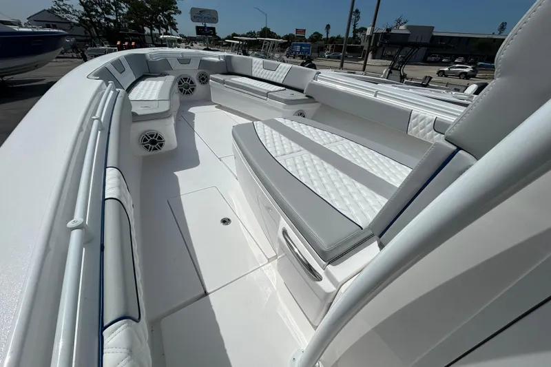 Slide: The Image of 2026 Contender 39 ST boat interior with white cushioned seating and speakers. - 19
