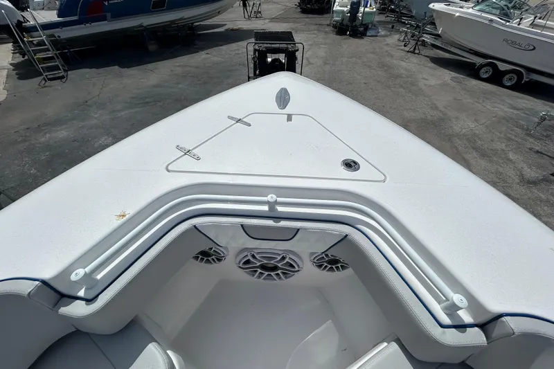 Slide: The Image of 2026 Contender 39 ST boat bow with seating and speakers in a marina. - 22