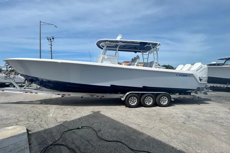 Slide: The Image of 2026 Contender 39 ST boat on trailer, side view under clear sky. - 3