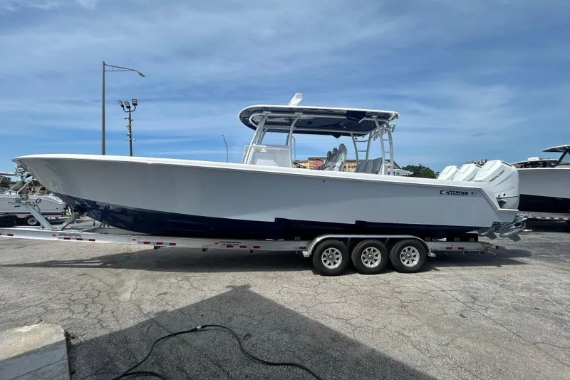 Slide: The Image of 2026 Contender 39 ST boat on trailer, featuring sleek design and triple outboard engines. - 4