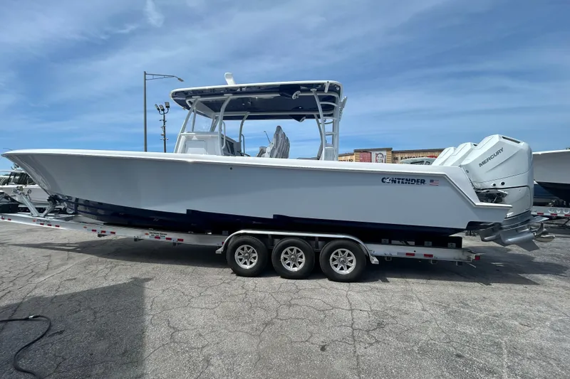 Slide: The Image of 2026 Contender 39 ST boat on trailer, featuring sleek design and powerful Mercury engines. - 5