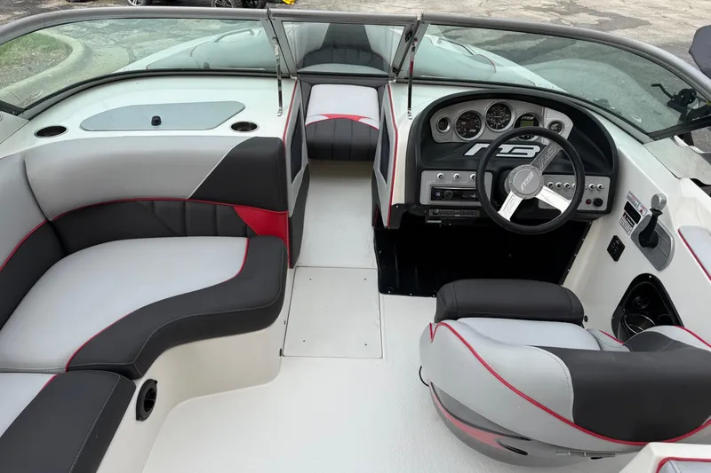 Slide: The Image of 2014 MBSPORTS B523 23V boat interior with sleek seating and modern dashboard design. - 10