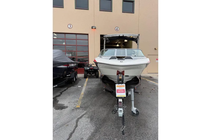 Slide: The Image of 2014 MBSPORTS B523 23V boat on trailer, parked outside a building, priced at $54,995. - 3