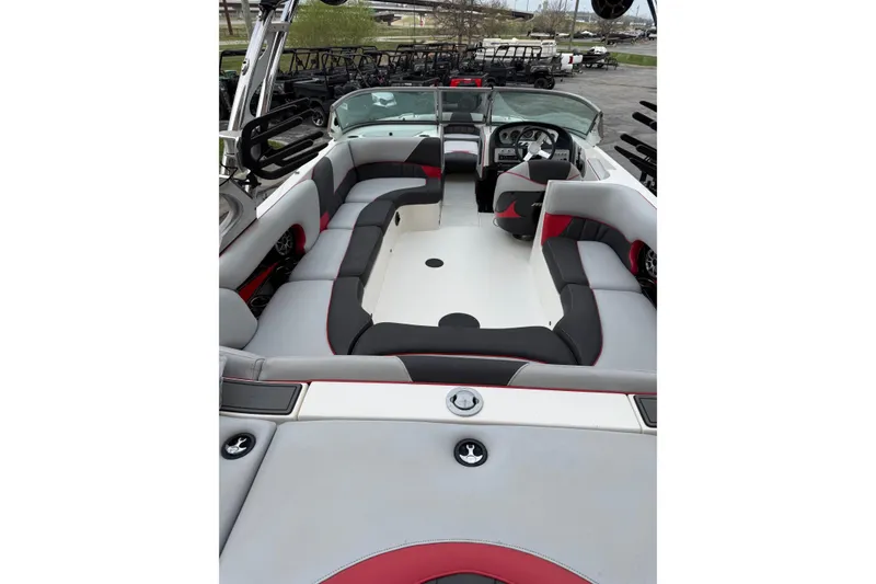 Slide: The Image of 2014 MBSPORTS B523 23V boat interior with gray and red seating, steering wheel, and dashboard. - 7