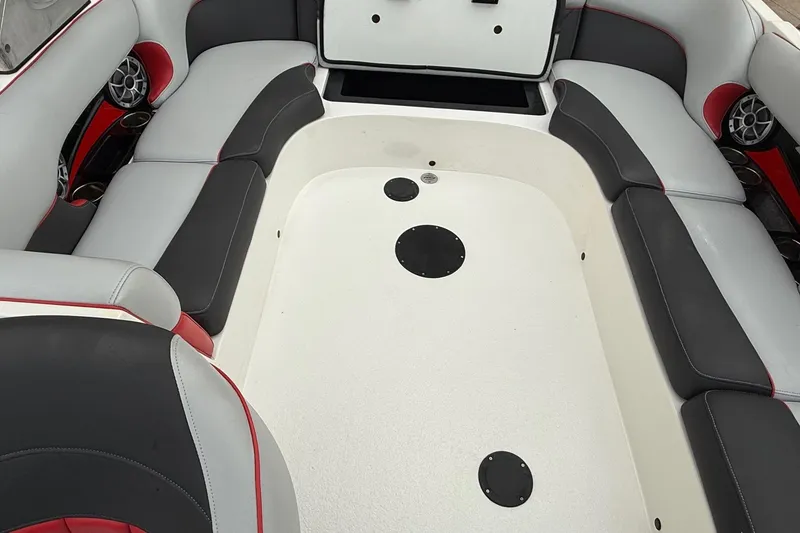 Slide: The Image of 2014 MBSPORTS B523 23V boat interior with gray and red seating, featuring built-in speakers. - 9