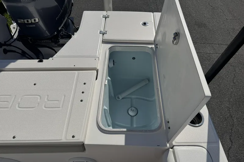 Slide: The Image of 2018 Robalo 226 Cayman boat with open storage compartment and Yamaha 200 engine. - 13