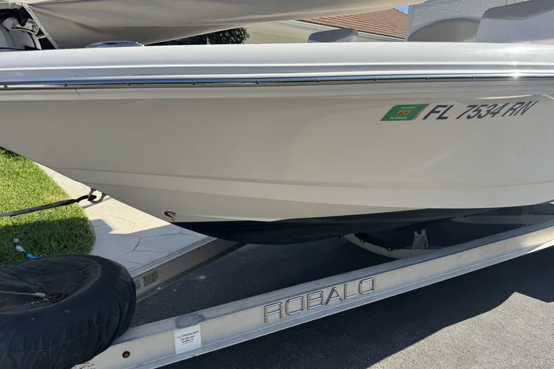 Slide: The Image of 2018 Robalo 226 Cayman boat on trailer, Florida registration visible. - 14