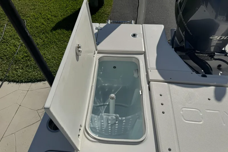 Slide: The Image of Open storage compartment on 2018 Robalo 226 Cayman boat, showcasing interior details. - 5