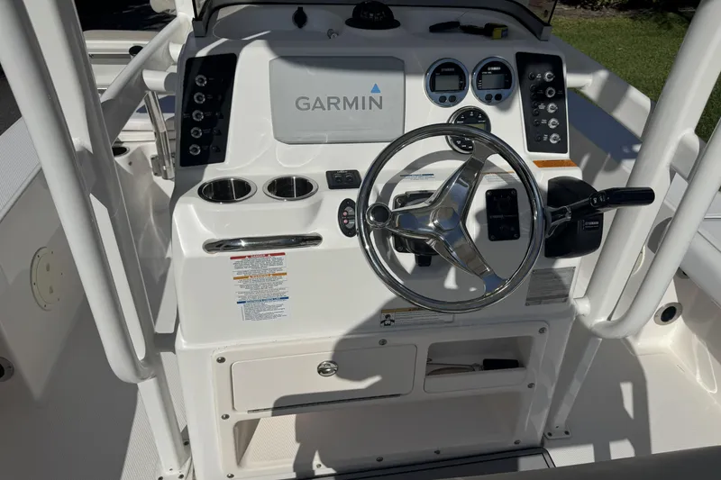 Slide: The Image of 2018 Robalo 226 Cayman boat dashboard with Garmin navigation system and steering wheel. - 7