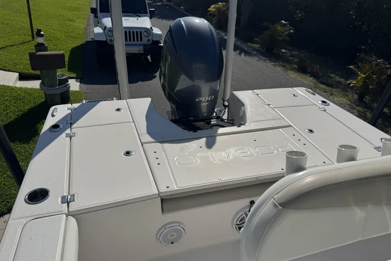 Slide: The Image of 2018 Robalo 226 Cayman boat with Yamaha 200 engine, parked near a white Jeep. - 8