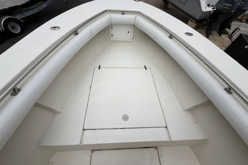Slide: The Image of 1985 SeaCraft SC 23 Classic boat interior with white seating and storage compartment. - 10
