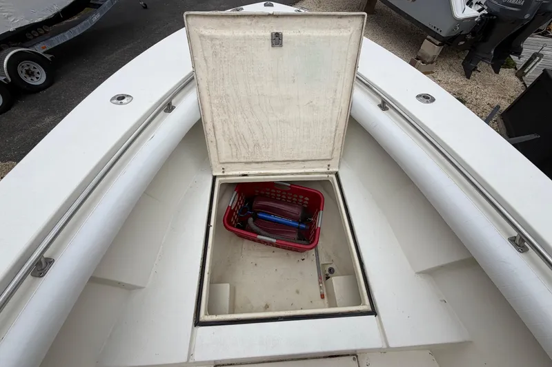 Slide: The Image of Open storage compartment on 1985 SeaCraft SC 23 Classic boat with tools inside. - 11