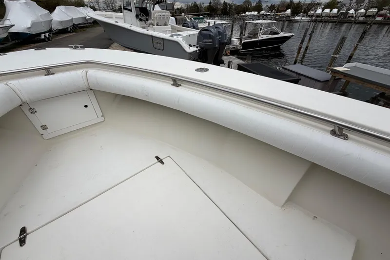 Slide: The Image of 1985 SeaCraft SC 23 Classic boat interior with white seating and storage compartment. - 12