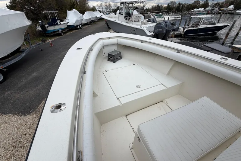Slide: The Image of 1985 SeaCraft SC 23 Classic boat docked, showcasing spacious deck and seating area. - 14