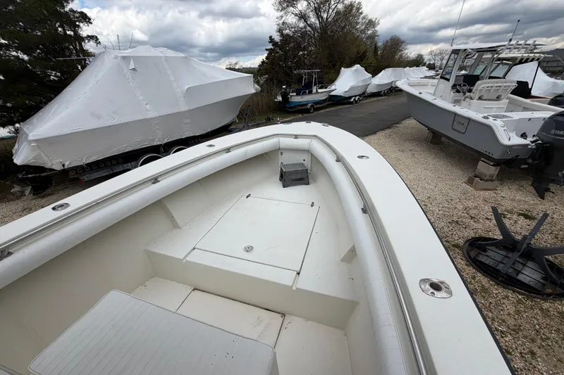 Slide: The Image of 1985 SeaCraft SC 23 Classic boat in storage, surrounded by other covered boats. - 15