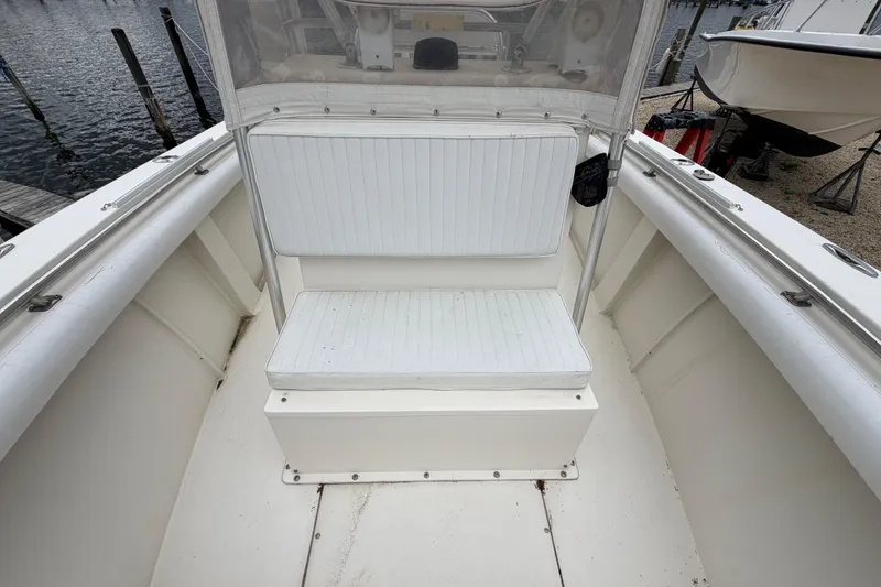 Slide: The Image of 1985 SeaCraft SC 23 Classic boat interior with white seating and clear windshield. - 16