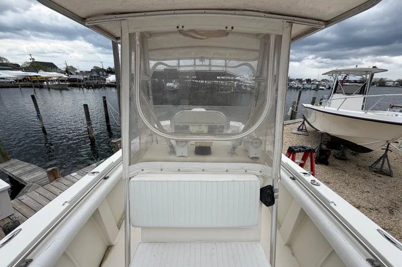 Slide: The Image of 1985 SeaCraft SC 23 Classic boat docked at marina under cloudy skies. - 17