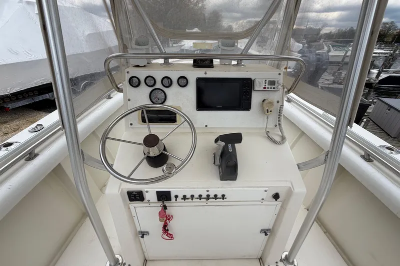 Slide: The Image of 1985 SeaCraft SC 23 Classic boat helm with steering wheel, gauges, and navigation equipment. - 18