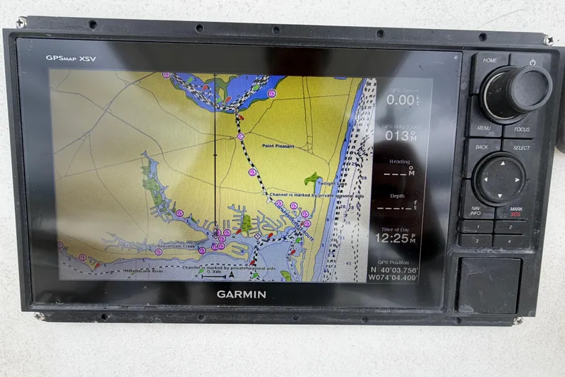 Slide: The Image of Garmin GPS display on 1985 SeaCraft SC 23 Classic, showing nautical map and navigation details. - 19