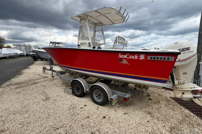Slide: The Image of 1985 SeaCraft SC 23 Classic boat on trailer under cloudy sky. - 2