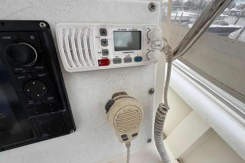 Slide: The Image of Control panel of a 1985 SeaCraft SC 23 Classic boat with radio and microphone. - 22