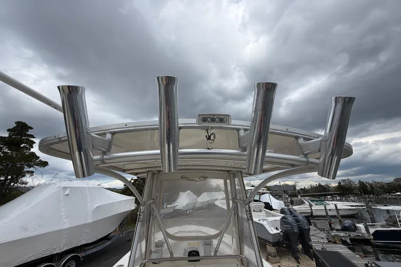 Slide: The Image of 1985 SeaCraft SC 23 Classic boat with rod holders, docked under cloudy skies. - 28