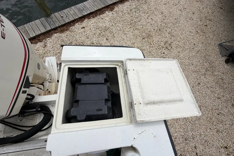 Slide: The Image of Open storage compartment on 1985 SeaCraft SC 23 Classic boat, near outboard motor. - 34