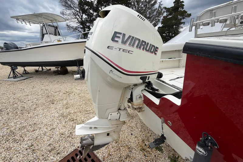 Slide: The Image of 1985 SeaCraft SC 23 Classic with Evinrude E-TEC outboard motor on gravel lot. - 6