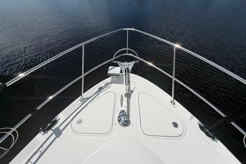 Slide: The Image of Bow view of 2006 Sea Ray 44 Sedan Bridge yacht on calm water. - 12