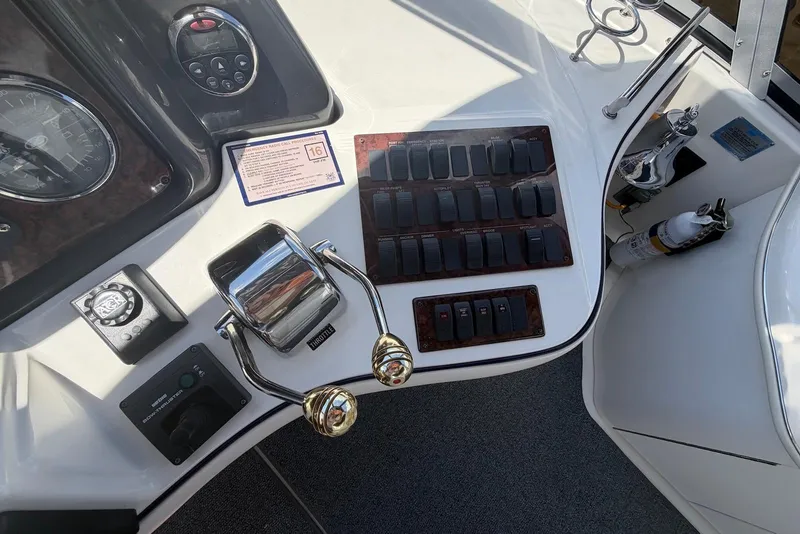 Slide: The Image of Control panel of a 2006 Sea Ray 44 Sedan Bridge yacht with switches and throttle. - 19