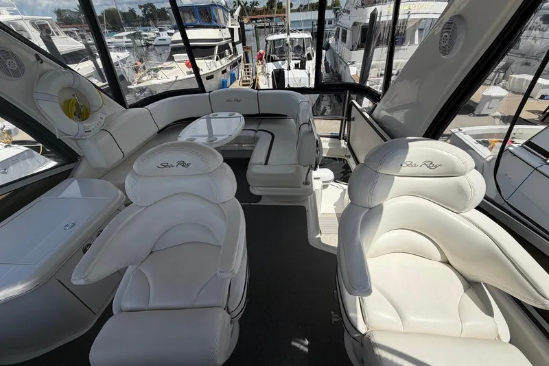 Slide: The Image of Luxurious interior of 2006 Sea Ray 44 Sedan Bridge yacht with plush seating and panoramic windows. - 21