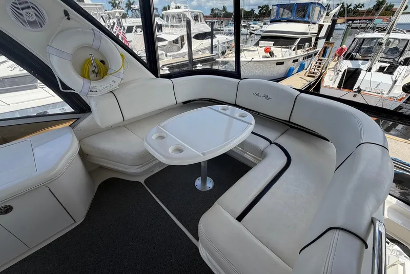 Slide: The Image of Luxurious seating area on a 2006 Sea Ray 44 Sedan Bridge yacht at a marina. - 22