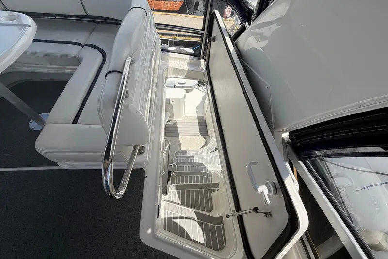 Slide: The Image of 2006 Sea Ray 44 Sedan Bridge interior with open storage compartment and seating area. - 24