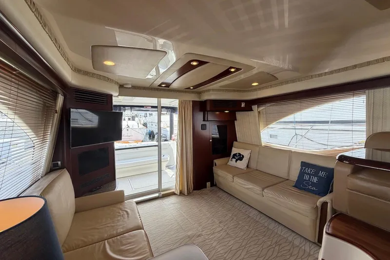 Slide: The Image of Luxurious interior of 2006 Sea Ray 44 Sedan Bridge yacht with elegant seating and decor. - 28