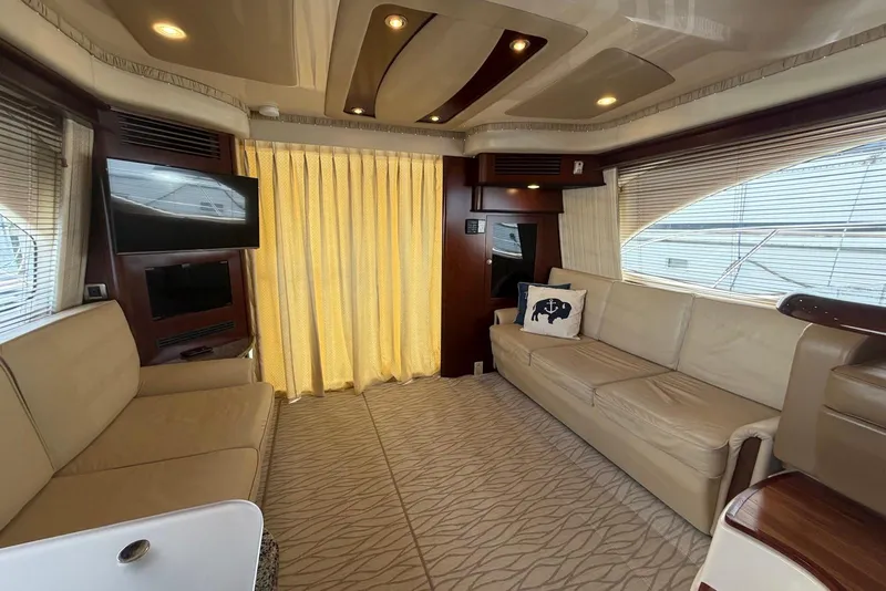 Slide: The Image of Luxurious interior of a 2006 Sea Ray 44 Sedan Bridge yacht with beige seating and modern decor. - 29