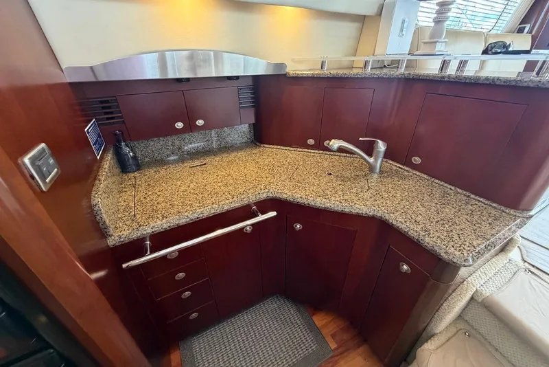 Slide: The Image of Luxurious kitchen area in a 2006 Sea Ray 44 Sedan Bridge yacht with granite countertops. - 35