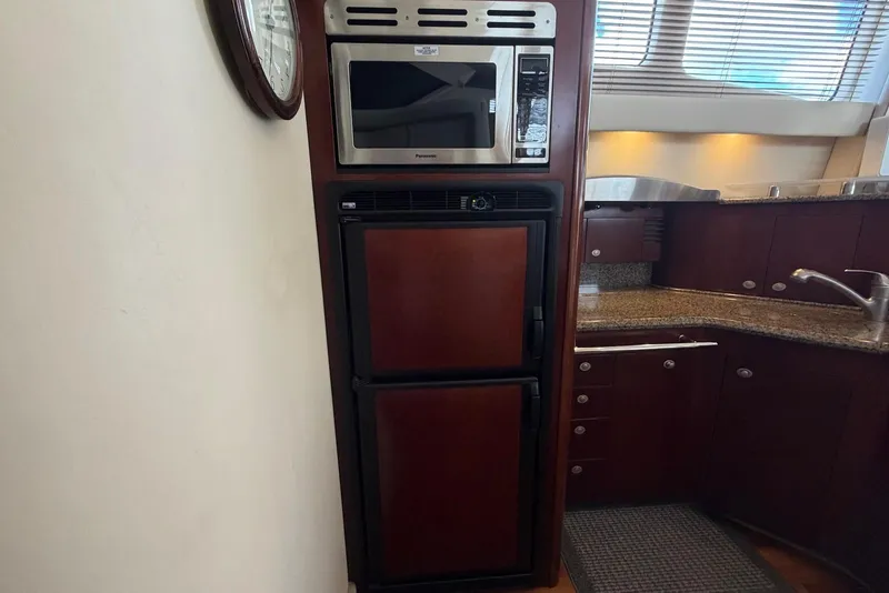 Slide: The Image of Galley kitchen in 2006 Sea Ray 44 Sedan Bridge with microwave and fridge. - 37