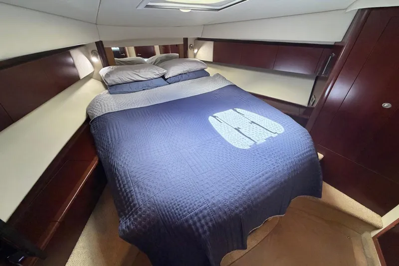 Slide: The Image of Luxurious bedroom interior of 2006 Sea Ray 44 Sedan Bridge yacht with blue bedding. - 39