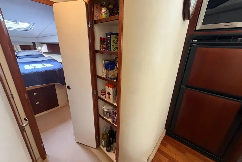 Slide: The Image of Interior of 2006 Sea Ray 44 Sedan Bridge with pantry and bedroom view. - 43