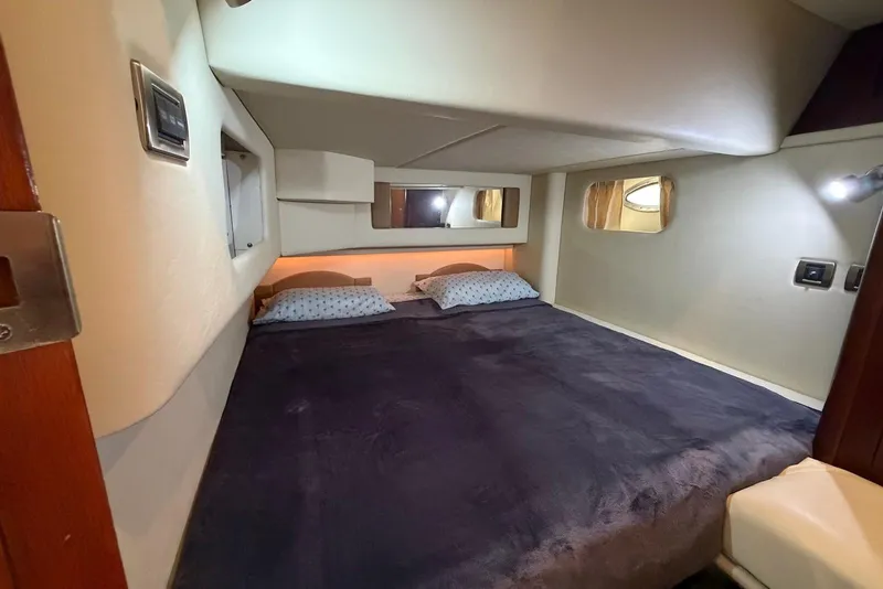 Slide: The Image of Luxurious bedroom interior of 2006 Sea Ray 44 Sedan Bridge yacht with cozy bedding. - 44