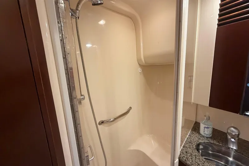 Slide: The Image of 2006 Sea Ray 44 Sedan Bridge cabin with twin beds and nautical-themed bedding. - 45