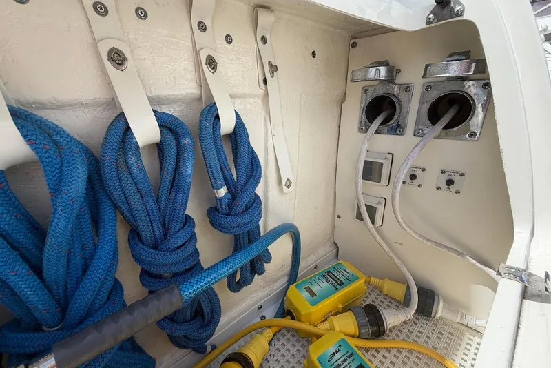 Slide: The Image of Storage compartment on 2006 Sea Ray 44 Sedan Bridge with cables and blue bag. - 51