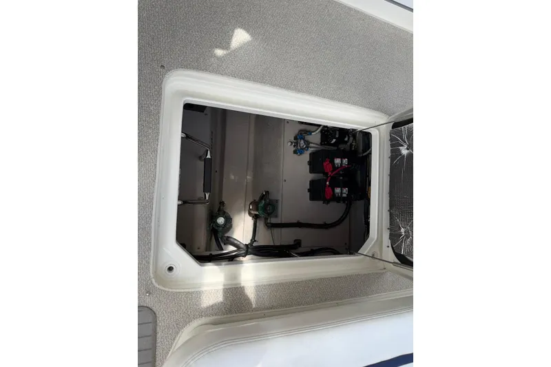 Slide: The Image of Storage compartment of a 2006 Sea Ray 44 Sedan Bridge with ropes and electrical connections. - 53