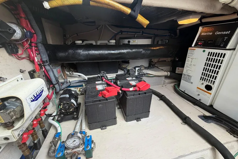 Slide: The Image of 2006 Sea Ray 44 Sedan Bridge engine compartment with visible batteries and wiring. - 55