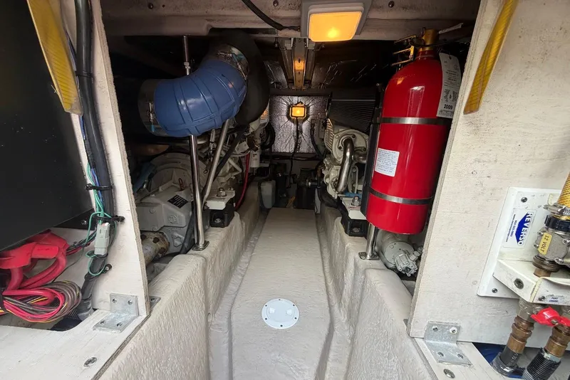Slide: The Image of Engine room of a 2006 Sea Ray 44 Sedan Bridge with visible fire extinguisher and machinery. - 60