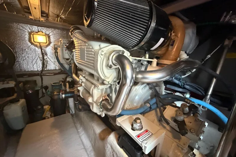 Slide: The Image of Engine room of a 2006 Sea Ray 44 Sedan Bridge yacht, showcasing mechanical components. - 61