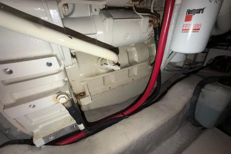 Slide: The Image of Engine compartment of a 2006 Sea Ray 44 Sedan Bridge with visible wiring and filter. - 64