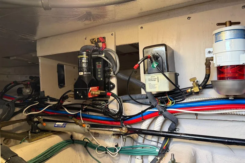 Slide: The Image of Engine room of a 2006 Sea Ray 44 Sedan Bridge with wiring and equipment. - 66