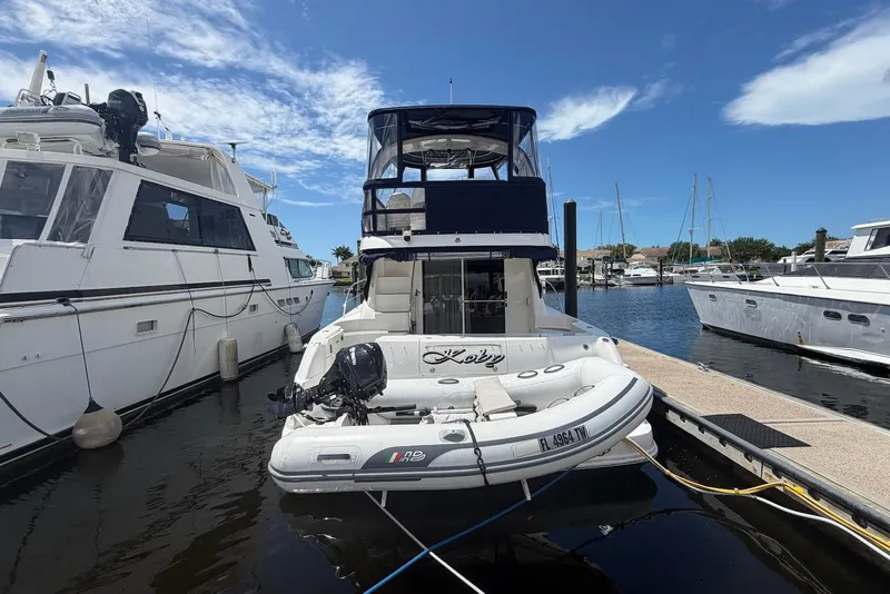 Slide: The Image of 2006 Sea Ray 44 Sedan Bridge yacht docked at marina with inflatable boat. - 7