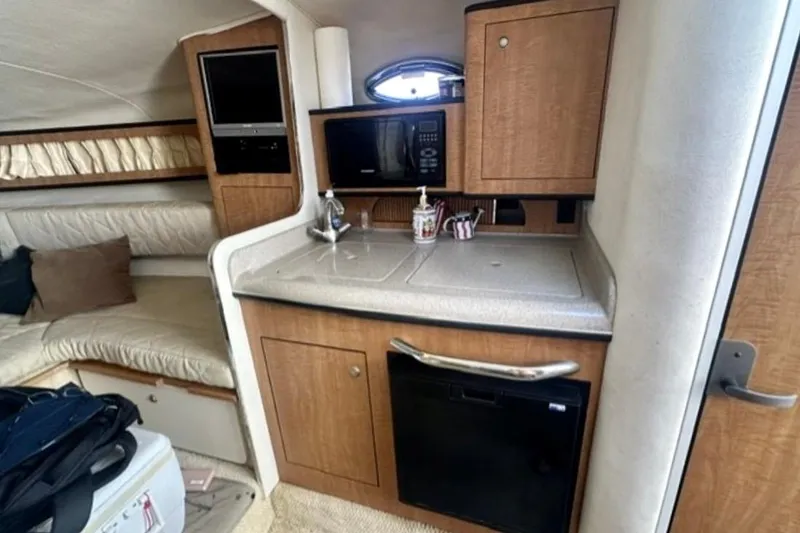 Slide: The Image of Interior of 2006 Sea Ray Sundancer 280 with kitchenette and seating area. - 11